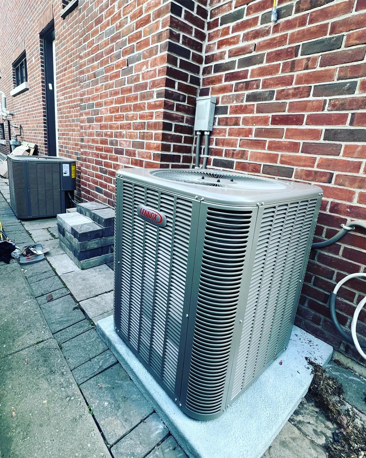 Outdoor condenser unit installed at the side of a GTA home
