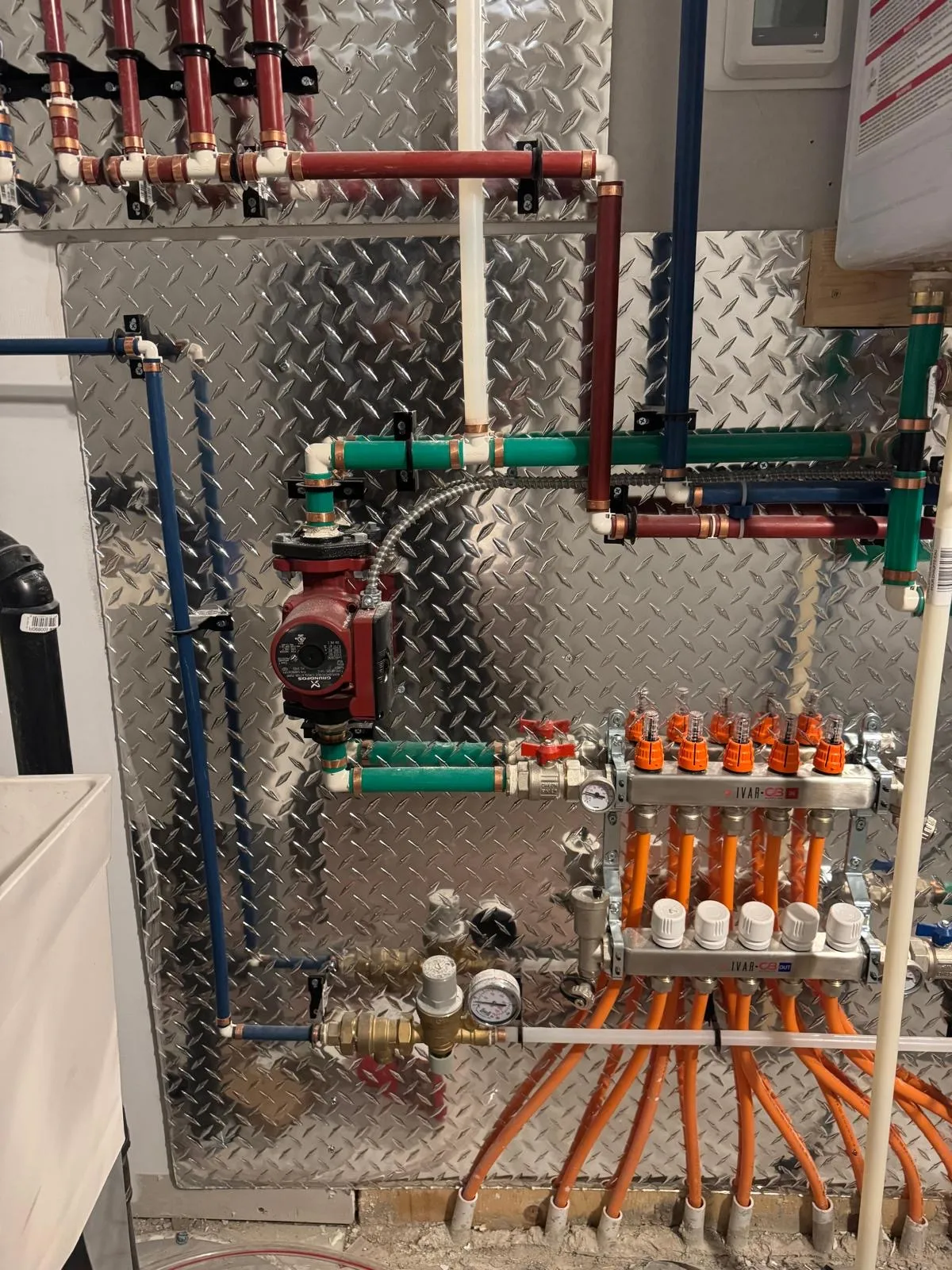 Hydronic system with copper piping, zone valves, and pumps