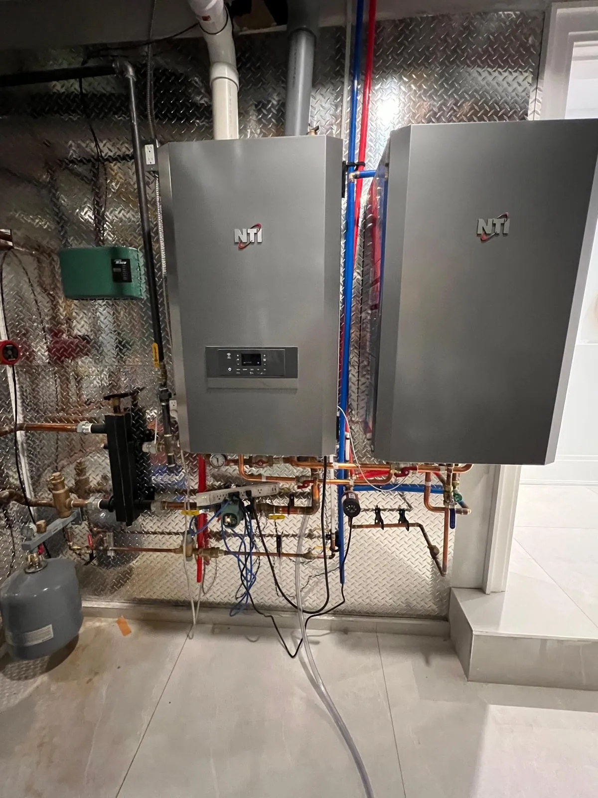 Pair of NTI high-efficiency wall-mounted gas boilers installed by Delson Air