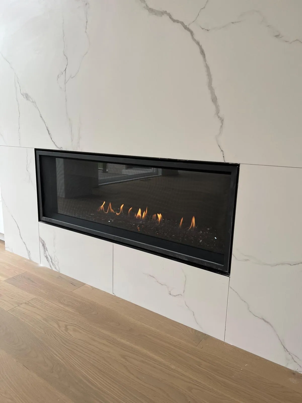 Grey-surround linear gas fireplace in a modern GTA home