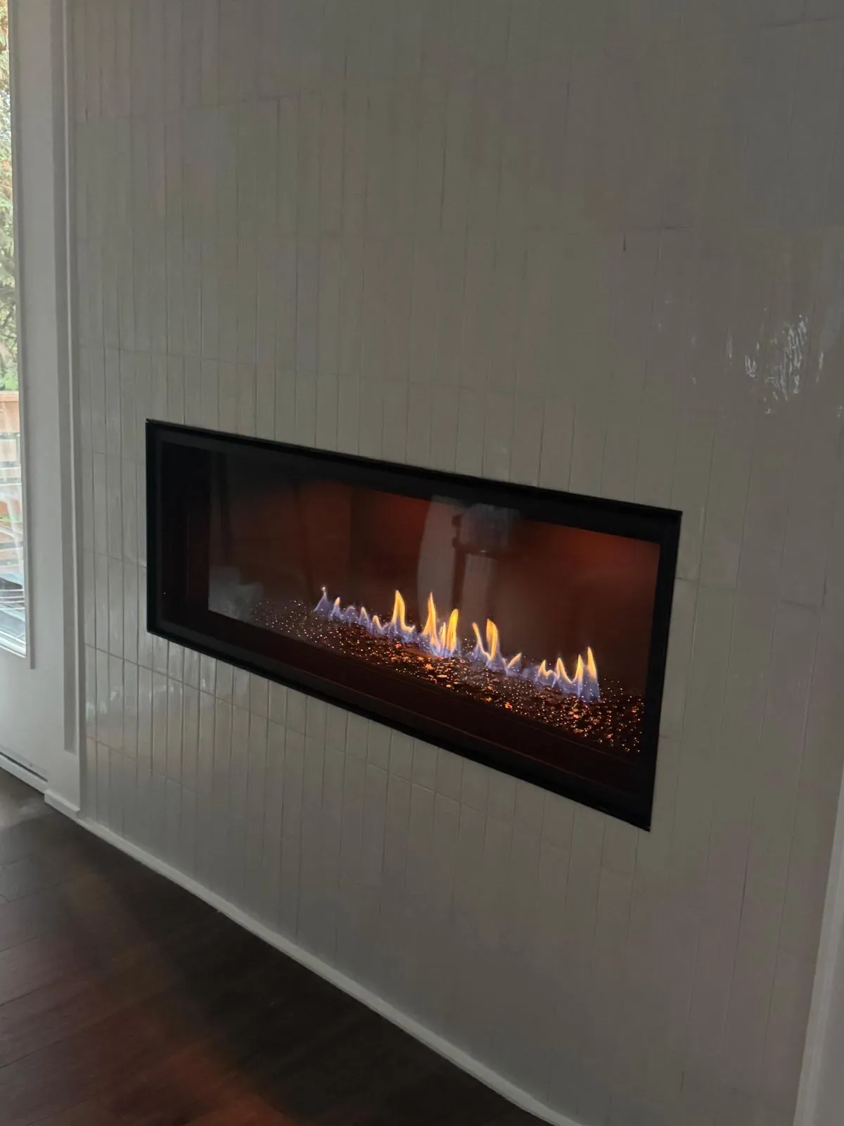 Modern linear gas fireplace in a grey textured wall