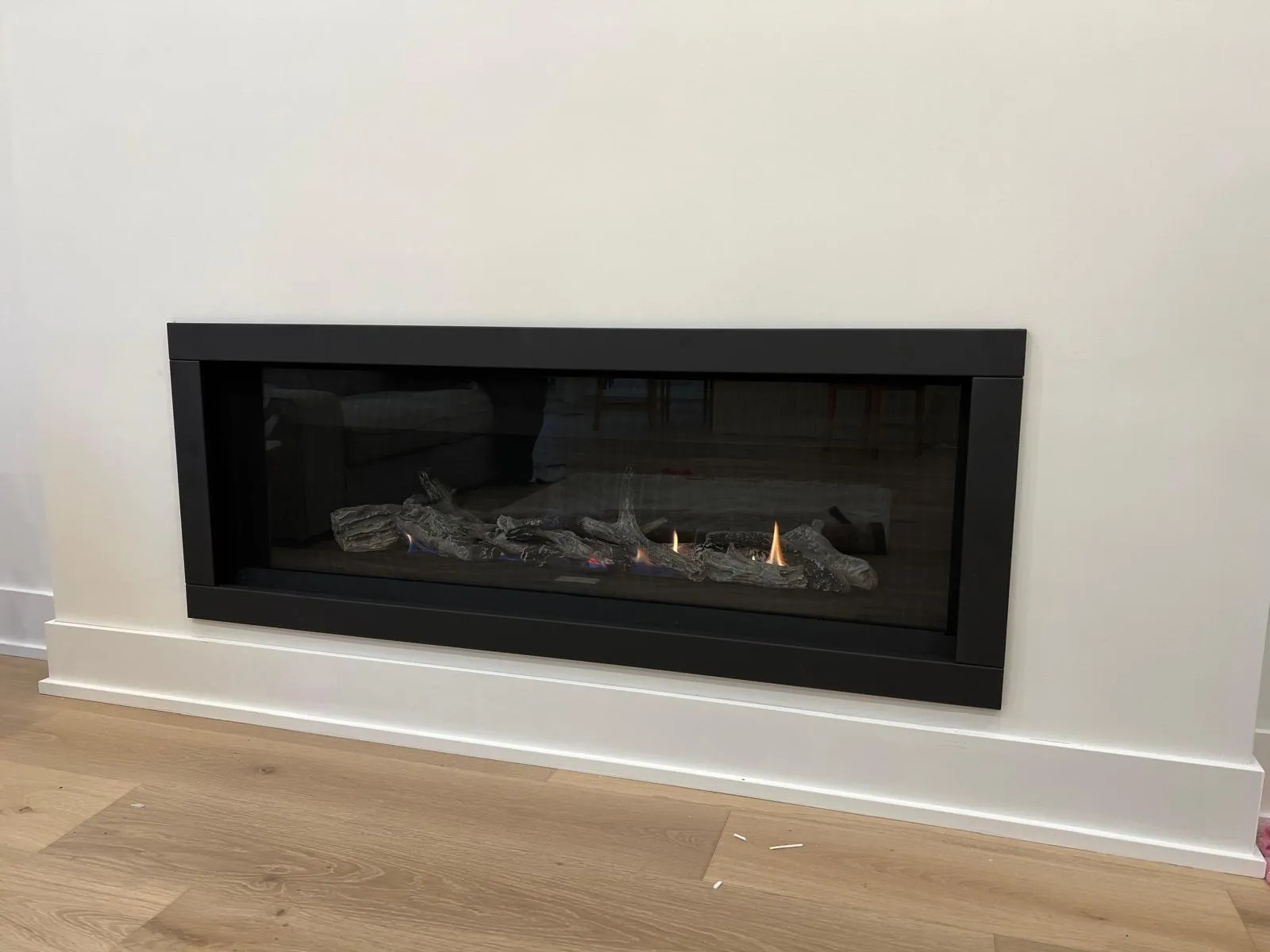 Clean white linear gas fireplace in a contemporary GTA living room