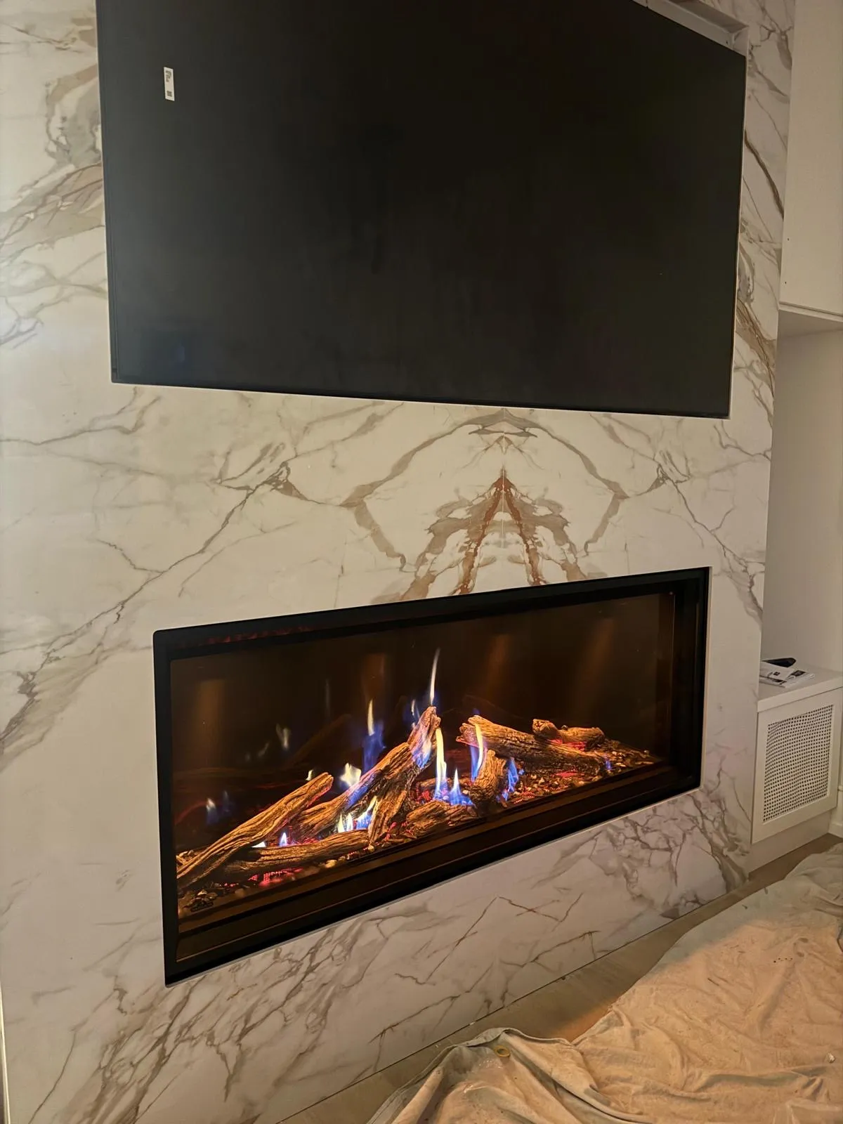 White marble linear gas fireplace in a contemporary GTA home