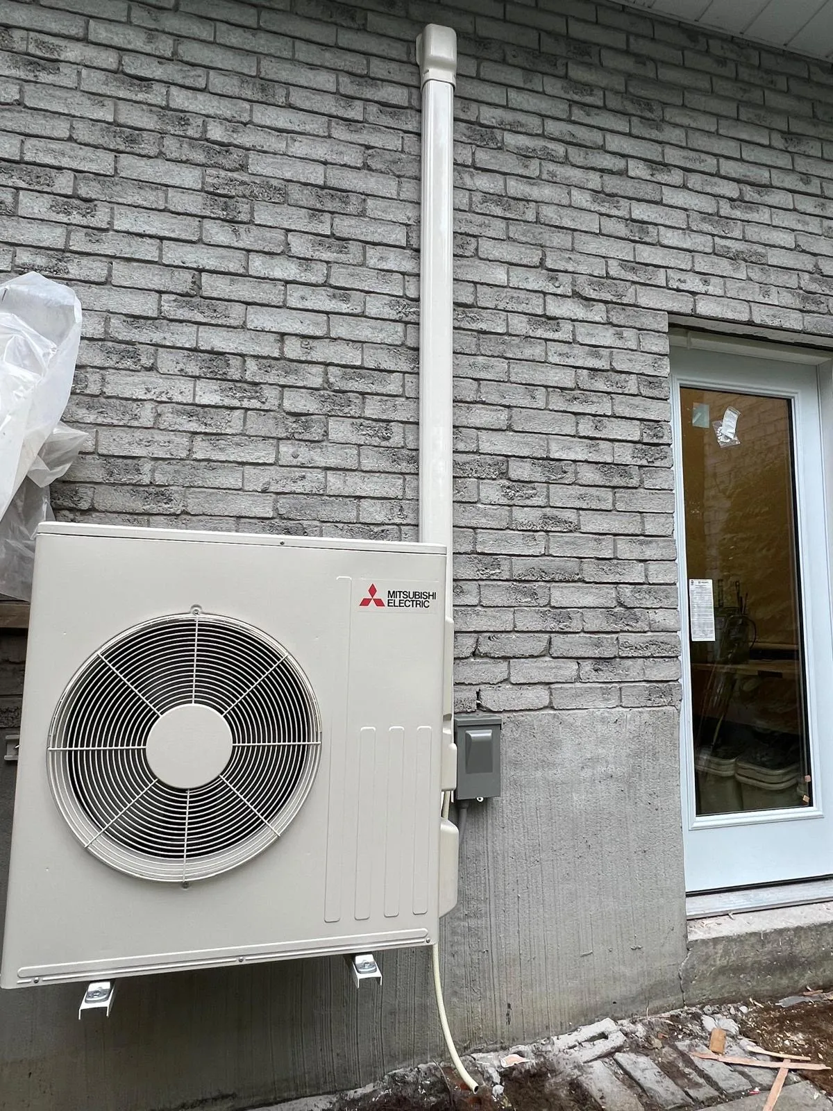 Mitsubishi Electric cold-climate heat pump on a GTA home brick wall