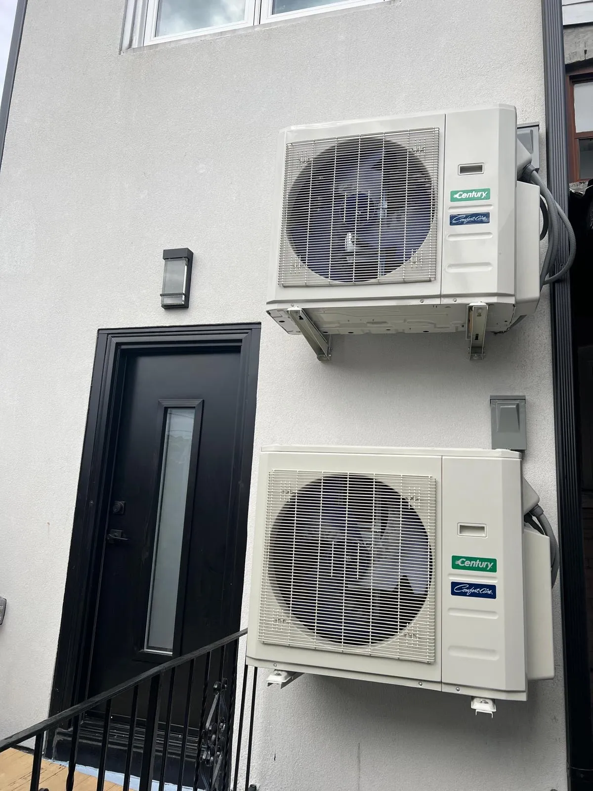 Two stacked outdoor heat-pump units installed against a GTA home