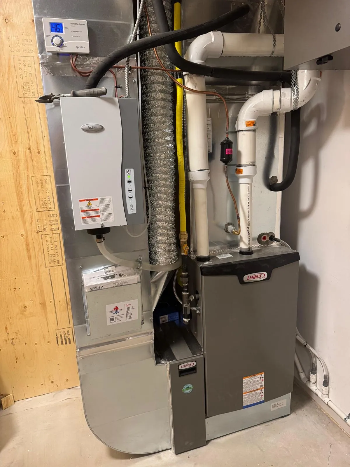 Navien tankless water heater installed in a tidy mechanical room