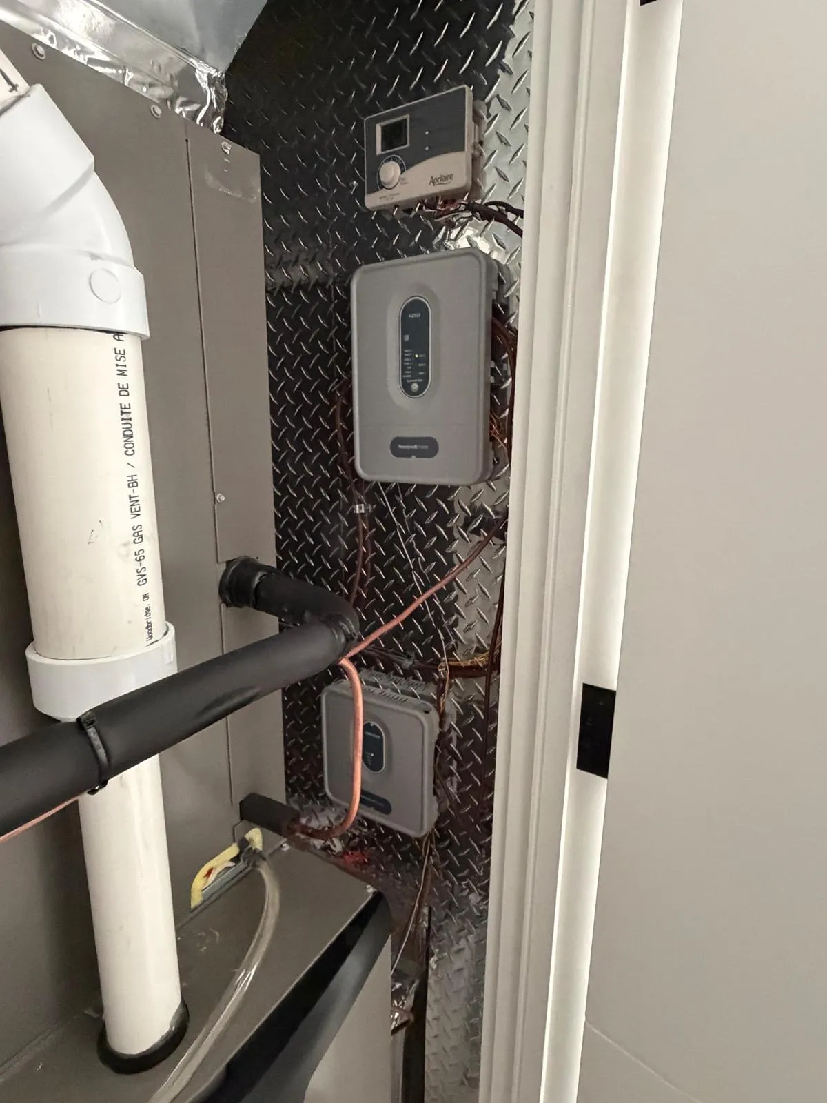 Wall-mounted tankless water heater with venting in a GTA home